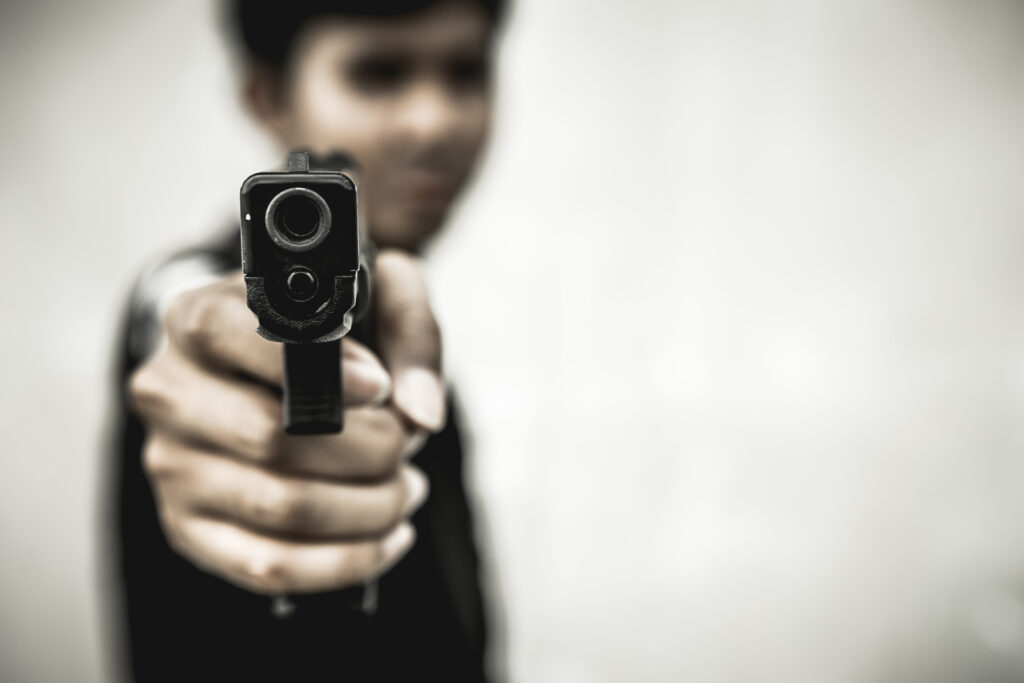 Young boy holding a gun.