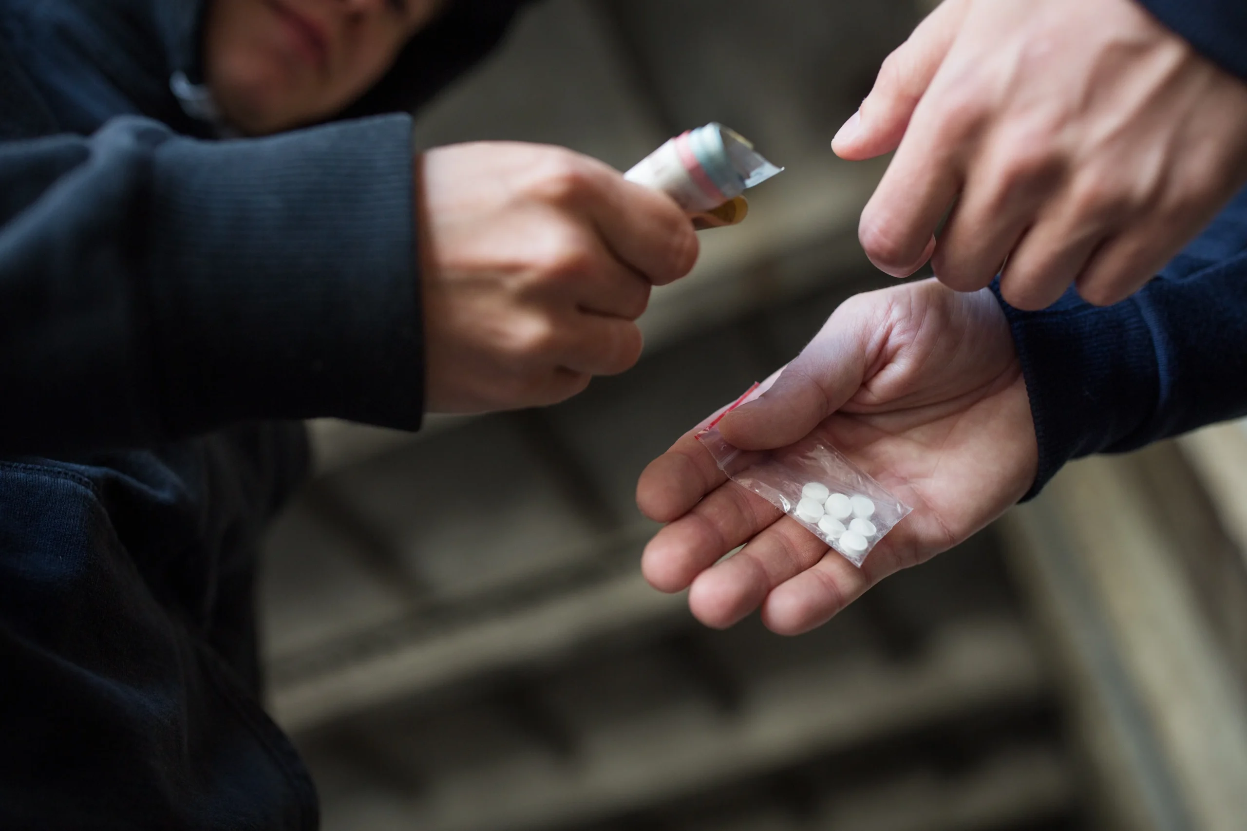 Two men exchanging drugs.